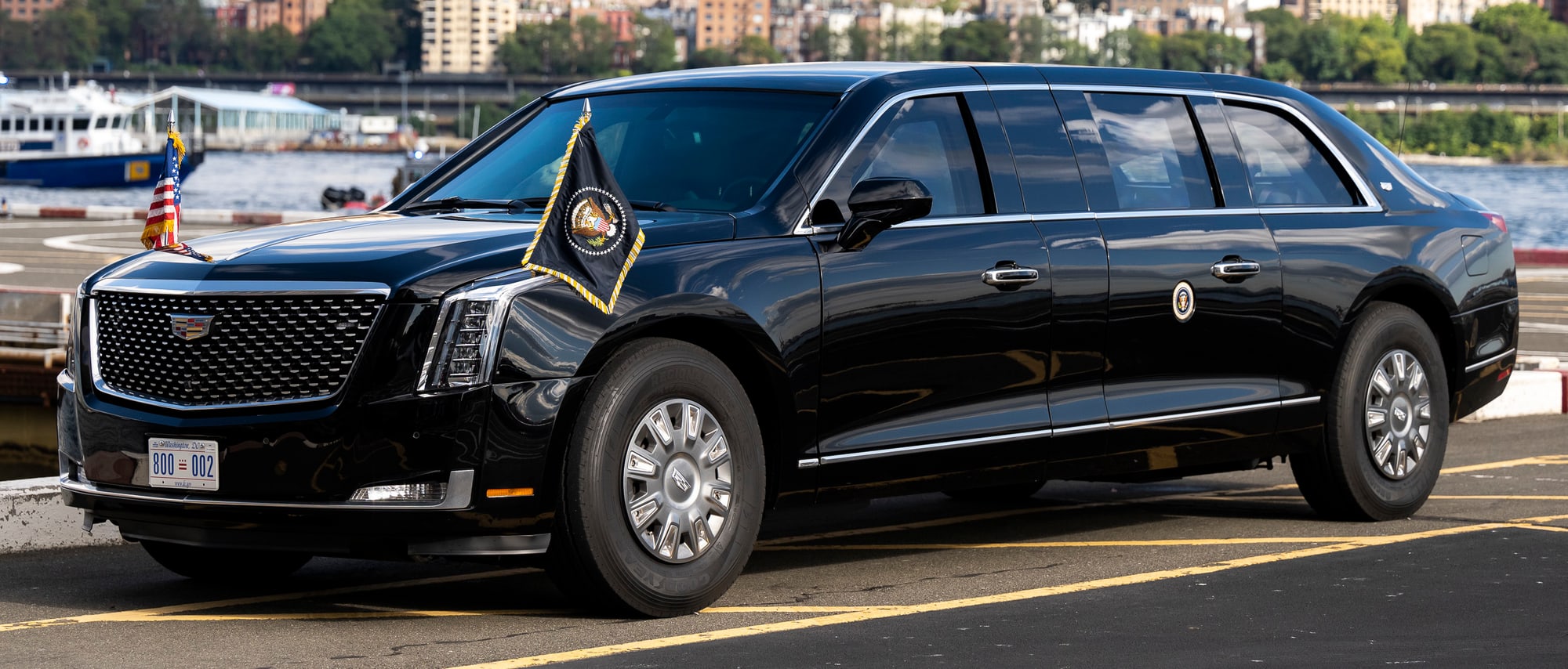 The black Cadillac presidential state car, with flags on its front wings, parked at a landing zone in New York in 2022