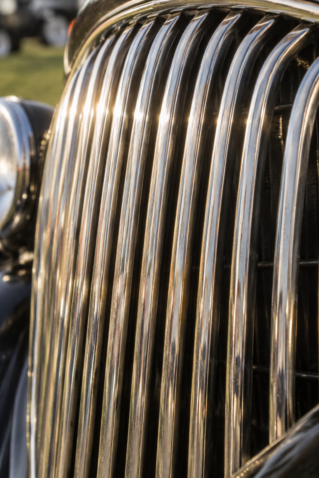 The curved chrome bars of a 1930s Art Deco waterfall grille, extreme close-up