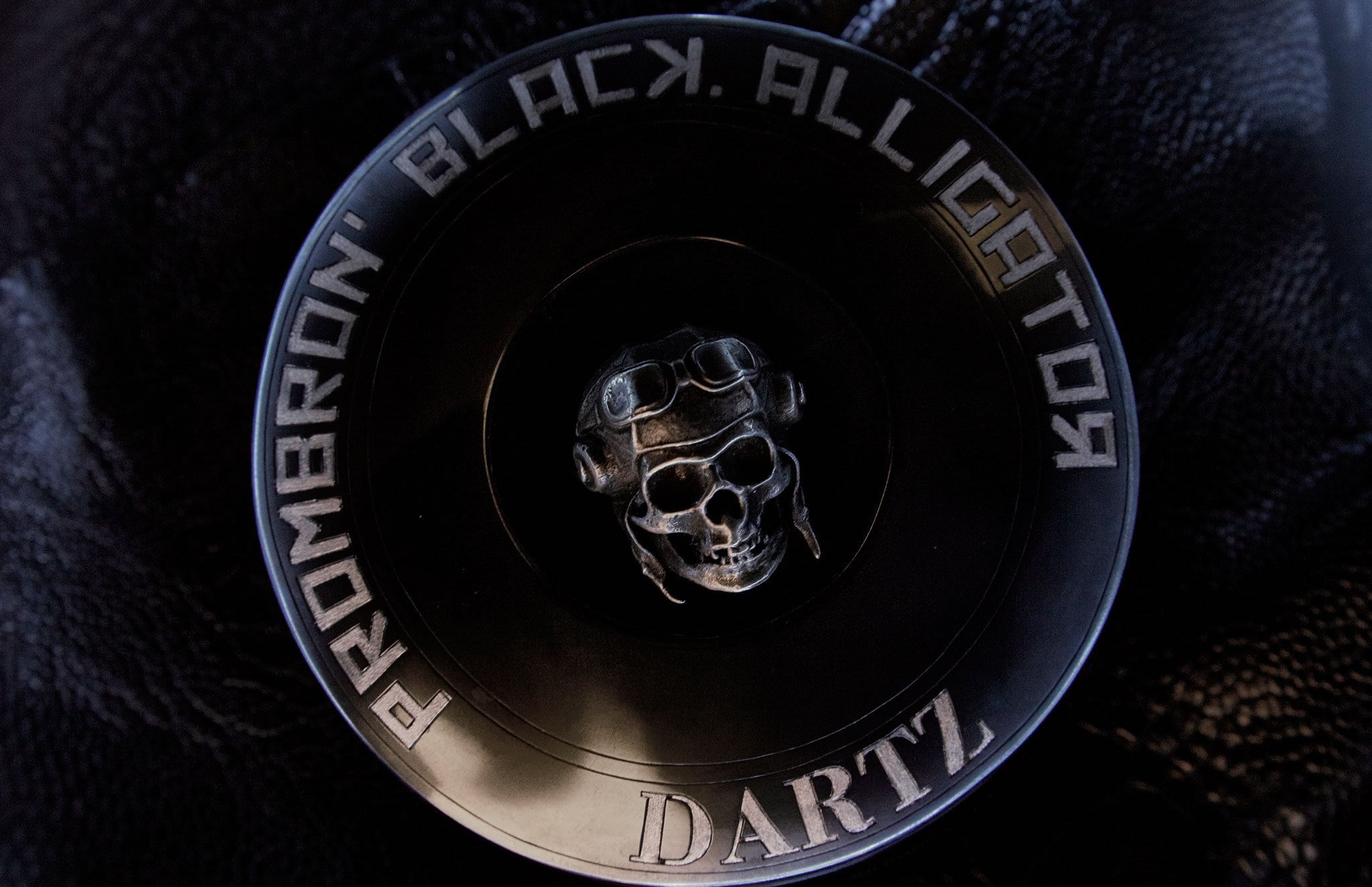 The DARTZ winged skull emblem in metal, ringed with the words Prombron’ Black Alligator