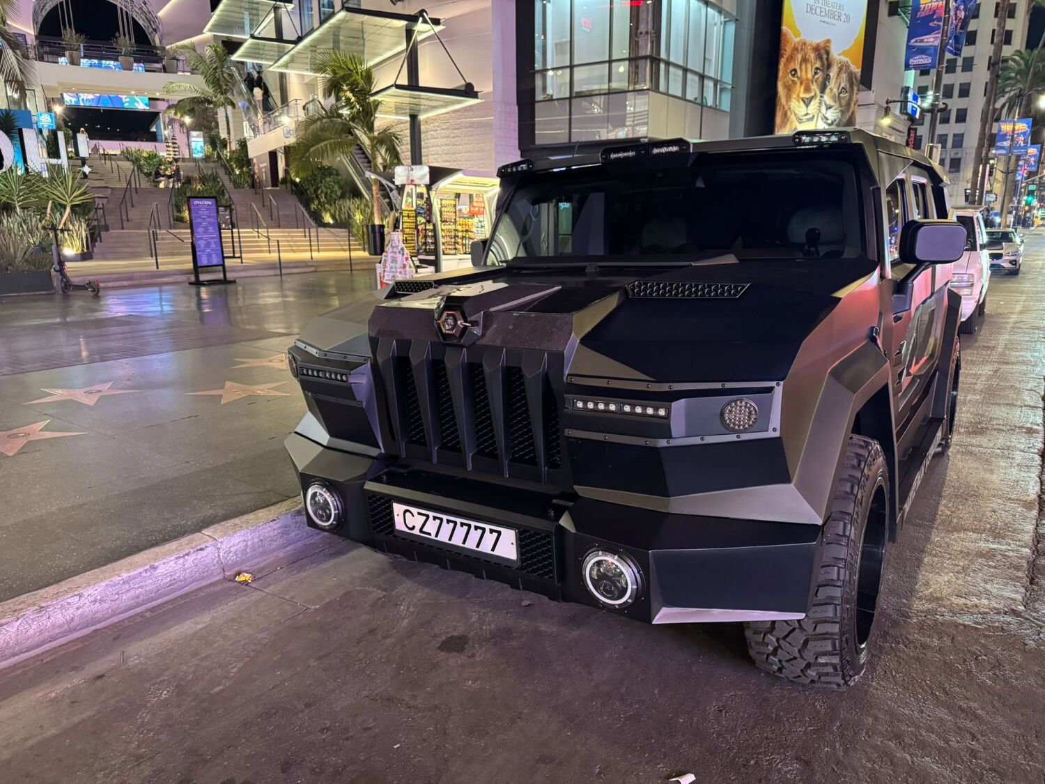 The DARTZ Black Stallion parked on Hollywood Boulevard at night, by the Walk of Fame stars