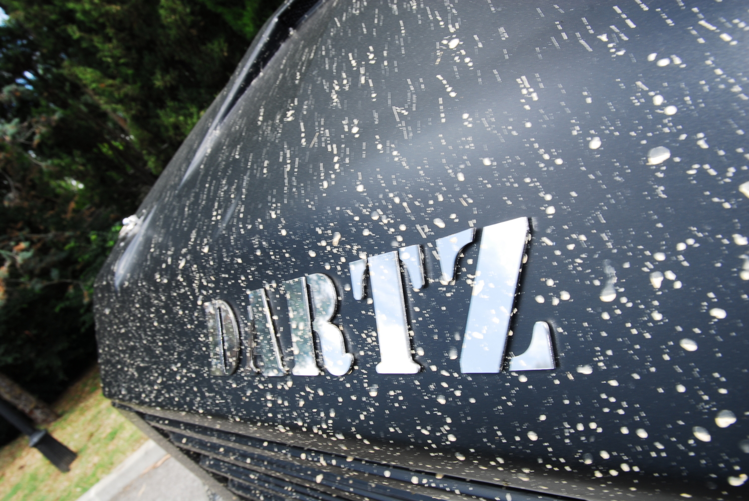 DARTZ letters on the black bonnet of the Iron Diamond, splashed after a dust run